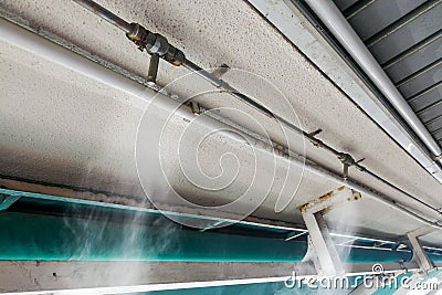 Water mist cooling system on ceiling lowers tropical ambient temperature Stock Photo