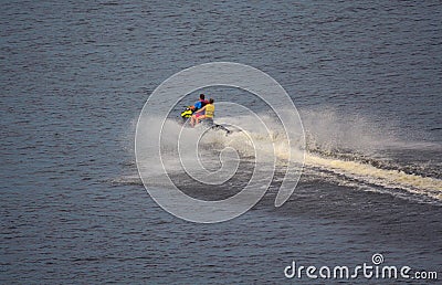 Water motorcycle is rapidly riding on the water surface Stock Photo