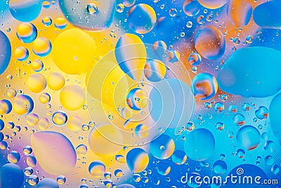 Water oil bubble macro abstract background flow liquid blue aqua yellow pink red colors Stock Photo