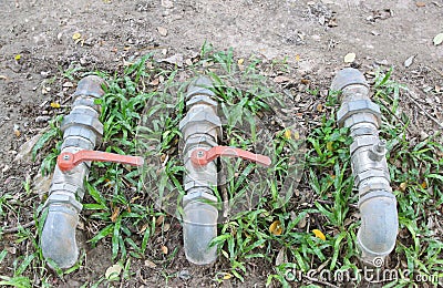 A water pipes on the green grass Stock Photo