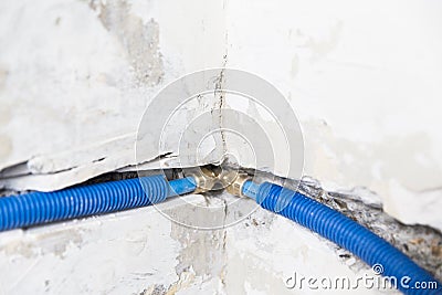 Water pipes made of polypropylene PEX in the wall, plumbing in the house. Installation of sewer pipes in a bathroom of an apartmen Stock Photo