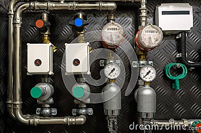 Water pipes, valves and manometers inside house Stock Photo