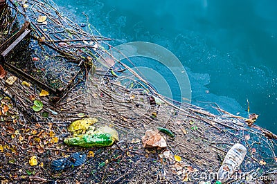 Water pollution old garbage and oil patches on water surface Stock Photo