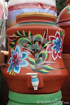 Water pot made from red clay and decorated with decorations Stock Photo