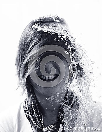 Water poured over laughing womans head in surprise Stock Photo
