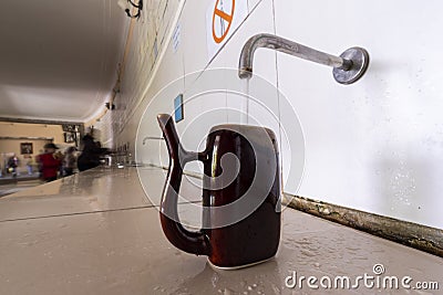 Water is poured into a special cup of mineral waters Stock Photo