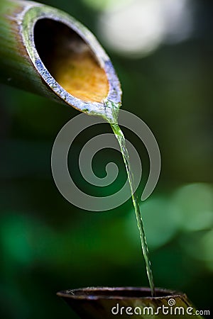 Water pouring from spout Stock Photo