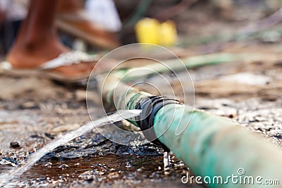 Water pours out of a leaky pipe Stock Photo