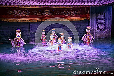 Water puppet show in Vietnam under purple lights Stock Photo