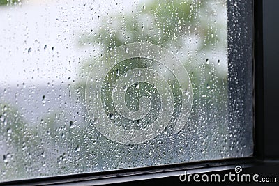 Water of Raindrops fresh on surface window glass in rainy season Selective focus Stock Photo