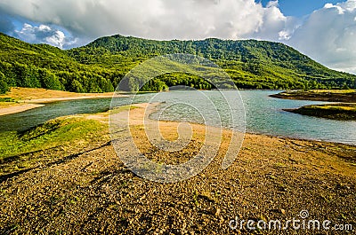 Water reservoir with green hill in background in Albania, near Fushe Stude Stock Photo