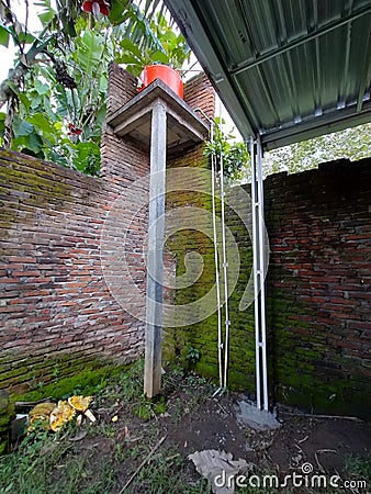 water reservoir is placed above orange water tower, brick wall Stock Photo