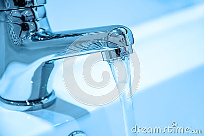 Running water from a faucet Stock Photo