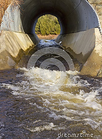 Water runoff through culvert Stock Photo