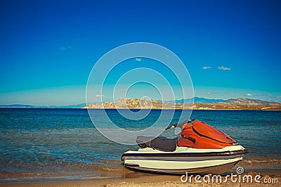 Water scooter on the beach in the bay, blue sky, mountains in the background Stock Photo