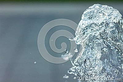 Water sculpture. Splashes frozen from the fountain in flight with droplets with blurred background. Copyspace Stock Photo