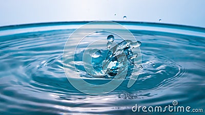 Water in the shape of two dolphins. Water splash close-up. Crown of blue water. Water drop. Frozen splashes Stock Photo