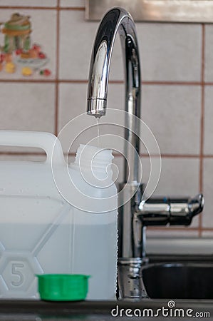 Water shortage. Filling slowly a tank Stock Photo