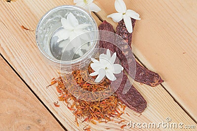 Water in silver bowl with Jasmine Safflower and Acacia concinna, Thailand Songkarn festival Stock Photo