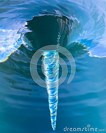 Water spiralling down a drain Stock Photo