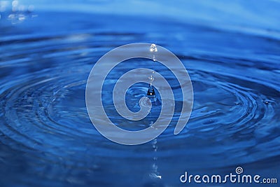 Water splash on blue background Stock Photo