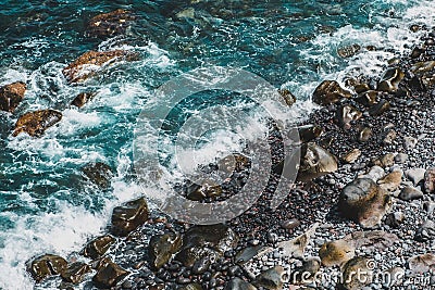 Water on stones - ocean waves on stone beach Stock Photo
