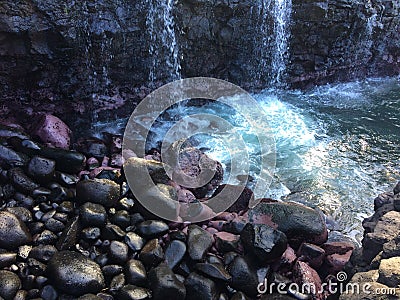 Water Stream Entering Pacific Ocean near Queen`s Bath in Princeville on Kauai Island, Hawaii. Stock Photo