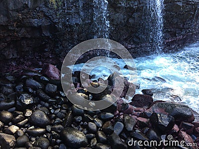 Water Stream Entering Pacific Ocean near Queen`s Bath in Princeville on Kauai Island, Hawaii. Stock Photo