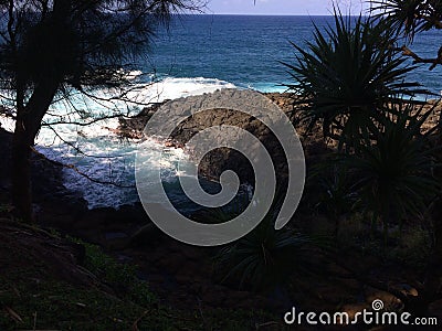 Water Stream Entering Pacific Ocean near Queen`s Bath in Princeville on Kauai Island, Hawaii. Stock Photo