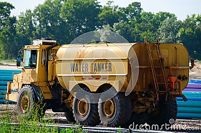 Water Tanker Word Truck at Construction Site Stock Photo