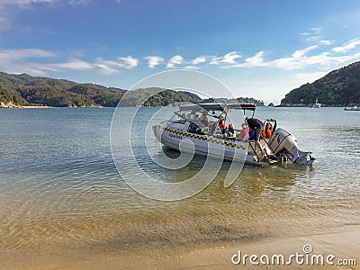 A water taxi picking up people from the beach at Watering Cove, Able Tasman National Park Editorial Stock Photo