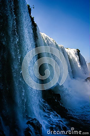 Water cascading over the Iguacu falls in Brazil Stock Photo