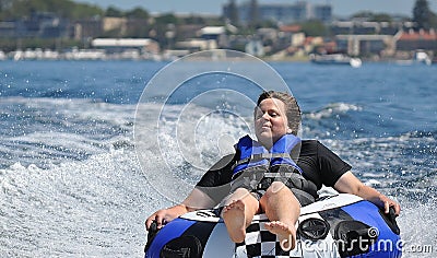 River water tubing skiing teen boy Stock Photo