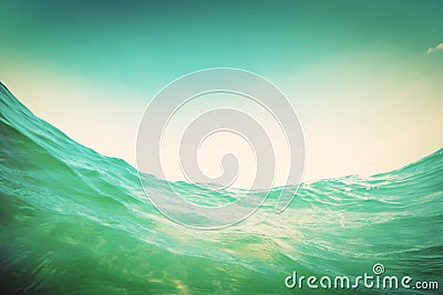 Water wave in the ocean. Underwater and blue sky. Vintage Stock Photo
