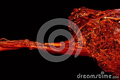 Water wave and splash red color on a black background Stock Photo