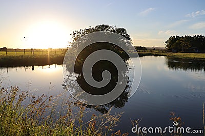 Water mirror in weir at sunset III Stock Photo