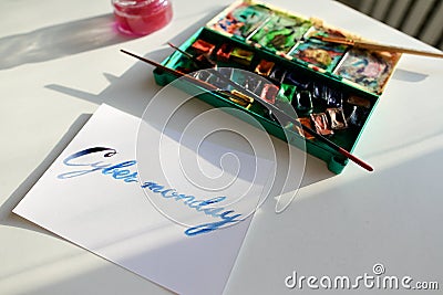 Watercolor inscription Cyber Monday on white sheet of paper on t Stock Photo