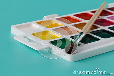 Watercolor paints in a box with a brush Stock Photo