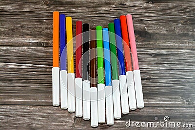 watercolor pens of different colors for painting on wooden background, back to school concept, school supplies and Stock Photo