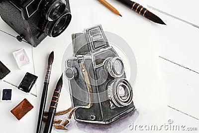 Watercolor sketch of retro camera, old camera, brushes and paints. Stock Photo