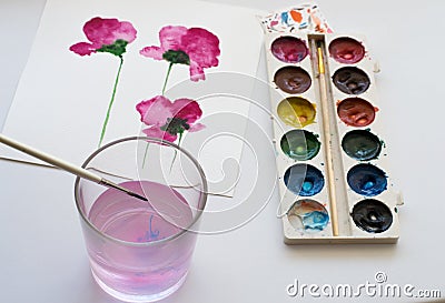 Watercolors, artistic tools and painting of beautiful pink flowers on white background, artistic workplace Stock Photo