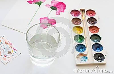 Watercolors, brush and painting of beautiful pink flowers on white background, artistic workplace Stock Photo