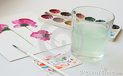 Watercolors, brush and painting of beautiful pink flowers on white background, artistic workplace Stock Photo