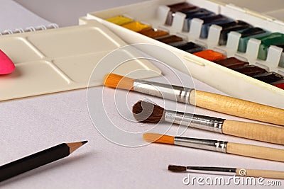 Watercolors, brushes and pencil Stock Photo