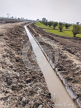Watercourse lined-watercourse irrigation- watercourse irrigation-course drain open watercourses agriculture land photo Stock Photo
