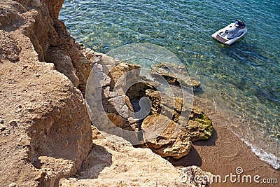 Watercraft near the rocky seashore Stock Photo