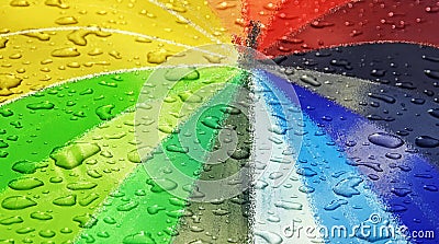 Waterdrops on rainbow coloured parasol Stock Photo