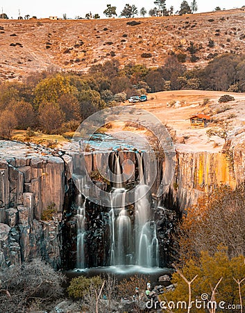 Waterfall at sunset in the basaltic prisms Stock Photo