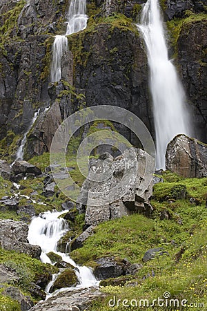 Waterfall and basaltic rocks. Iceland. Seydisfjordur. Stock Photo