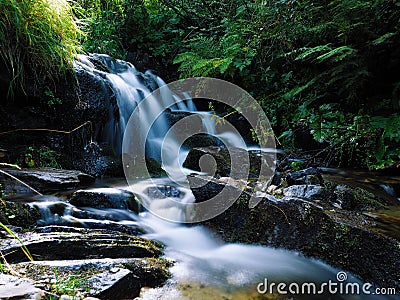 Waterfall at the carpatian mountains green forest Stock Photo